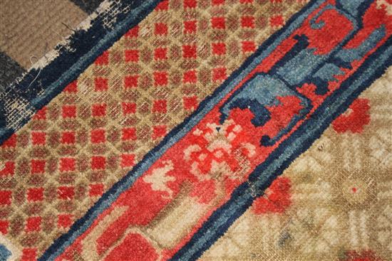 A small Chinese Suiyvan carpet, the fawn ground field woven with a lattice pattern, each cross centred by flowerheads, within a border